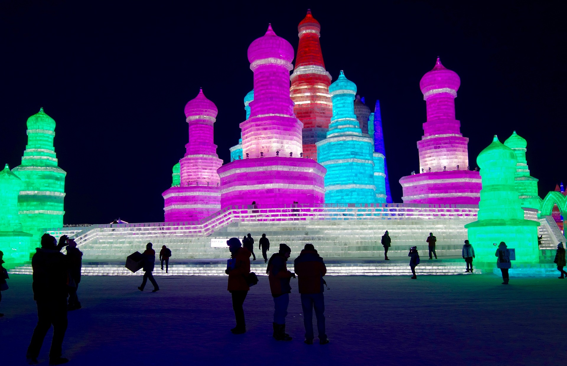 A picture of ice scupltures backlit by colored lights.